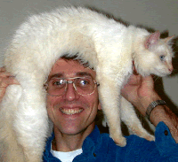 Photo of Dave with his fur hat (aka Ceilidh, the white cat).